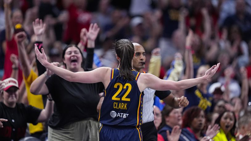 Indiana Fever guard Caitlin Clark (22) celebrates after a three-point basket against the Dallas Wings in the first half of a WNBA basketball game in Indianapolis, Sunday, Sept. 15, 2024. (AP Photo/Michael Conroy)