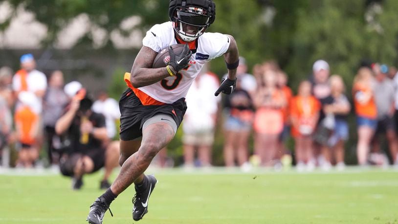 Cincinnati Bengals wide receiver Tee Higgins runs downfield after completing a catch during the team's NFL football training camp Sunday, July 28, 2024, in Cincinnati. (AP Photo/Kareem Elgazzar)