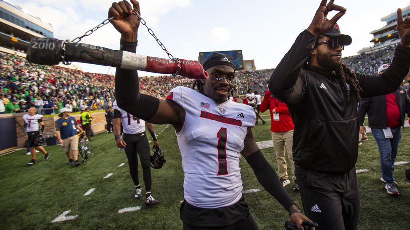 Northern Illinois defensive back Jashon Prophete (1) celebrates with a dog bone on a chain after defeating Notre Dame in an NCAA college football game Saturday Sept. 7, 2024, in South Bend, Ind. (AP Photo/Michael Caterina)