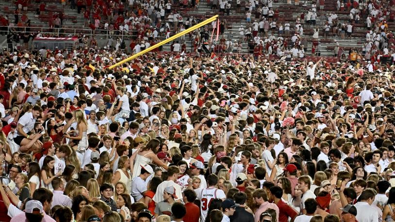 Arkansas fans rush the field to celebrate after Arkansas upsets Tennessee 19-14 during an NCAA college football game, Saturday, Oct. 5, 2024, in Fayetteville, Ark. (AP Photo/Michael Woods)