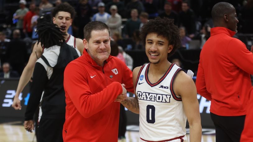 Dayton's Darren Hertz and Javon Bennett celebrate after a victory against Nevada in the first round of the NCAA tournament on Thursday, March 21, 2024, at the Delta Center in Salt Lake City, Utah. David Jablonski/Staff