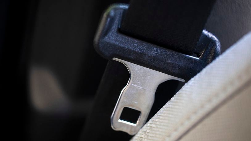 A seat belt for the right front passenger seat is shown in a vehicle on Monday, Aug. 21, 2023. The Department of Transportation is proposing new rules designed to encourage seat belt use by car and truck passengers, including those sitting in the back seat. The new rules proposed by the National Highway Traffic Safety Administration would require manufacturers to equip vehicles with additional seat belt warning systems for the right front passenger and for rear seats to encourage increased seat belt use. (AP Photo/Jenny Kane)