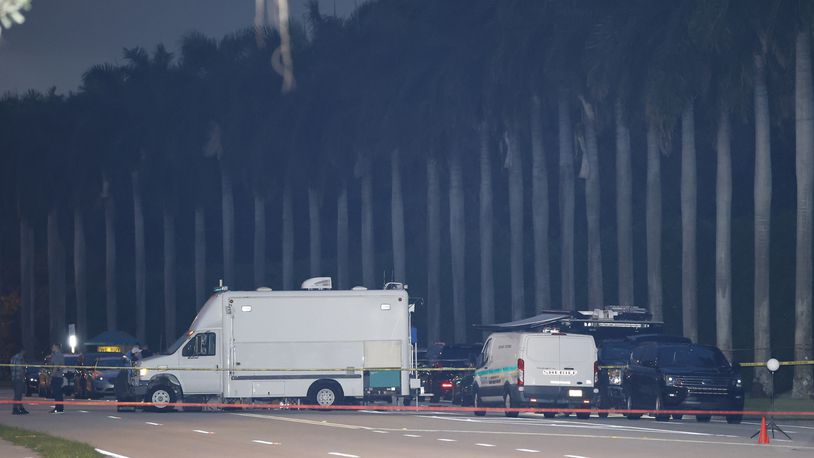 Police crime scene vehicles are seen at Trump International Golf Club after police closed off the area following the apparent assassination attempt of Republican presidential nominee former President Donald Trump in West Palm Beach, Fla., Sunday, Sept. 15, 2024. (AP Photo/Terry Renna)