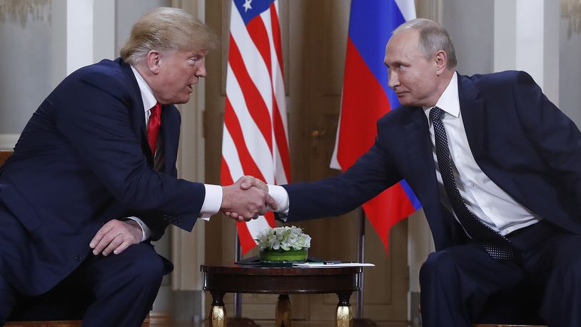 FILE - U.S. President Donald Trump, left, and Russian President Vladimir Putin, right, shake hands at the beginning of a meeting at the Presidential Palace in Helsinki, Finland, July 16, 2018. (AP Photo/Pablo Martinez Monsivais, File)