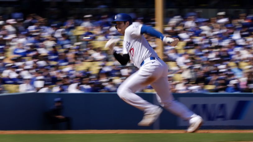 Los Angeles Dodgers' Shohei Ohtani heads to third as Freddie Freeman grounds into a double play to end the third inning of a baseball game against the Colorado Rockies, Sunday, Sept. 22, 2024, in Los Angeles. (AP Photo/Mark J. Terrill)