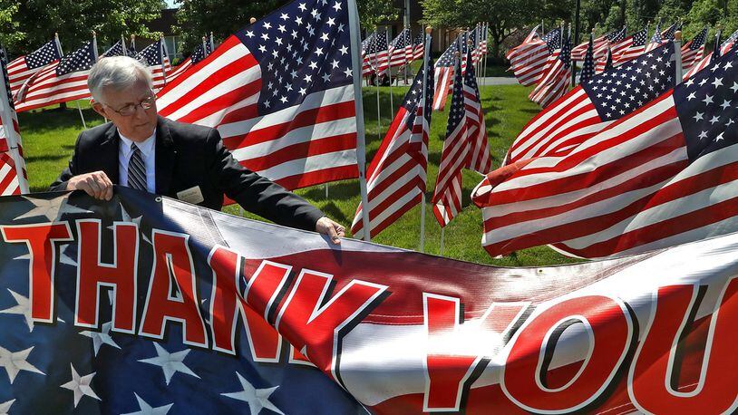 Ron Staffan, an employee of Jackson Lytle & Lewis Life Celebration Center, straightens the sign in front of the Field Of Honor on the Center’s front lawn along North Limestone Street. The Field of Honor, made up of hundreds of American flags, was on display from June 6-14. The purpose of the Field Of Honor is to show appreciation for active members of the military as well as our veterans. This was the 11th Honor Field that Jackson, Lytle & Lewis has hosted. BILL LACKEY/STAFF