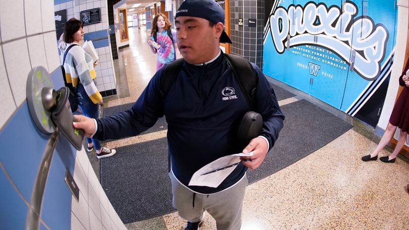 Springfield City School District Board of Education has approved the purchase of Yondr Phone-Free pouches for the 2024-25 school year for students in 7-12 grades. In this AP file photo, Anthony Bruno, a student at the Washington Junior High School, used the unlocking mechanism as he left classes for the day to open the bag that his cell phone was sealed in during the school day, in Washington, Pa. (AP Photo/Keith Srakocic)