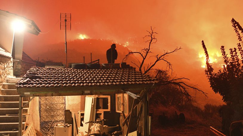 A wildfire approaches the village of Kallithea as fanned by strong winds raged uncontrolled despite the attempts of hundreds of firefighters to stop it, some 149 kilometers (93 miles) west of Athens, Greece, in the region of Corinthia, late Sunday, Sept. 29, 2024. (AP Photo)