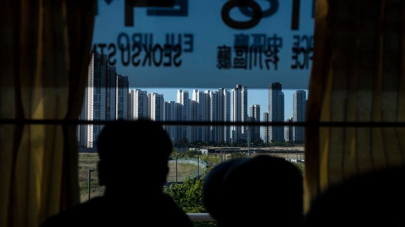 A tourist views high-rise apartment buildings from a bus in Incheon, South Korea, Thursday, May 16, 2024. (AP Photo/Jae C. Hong)