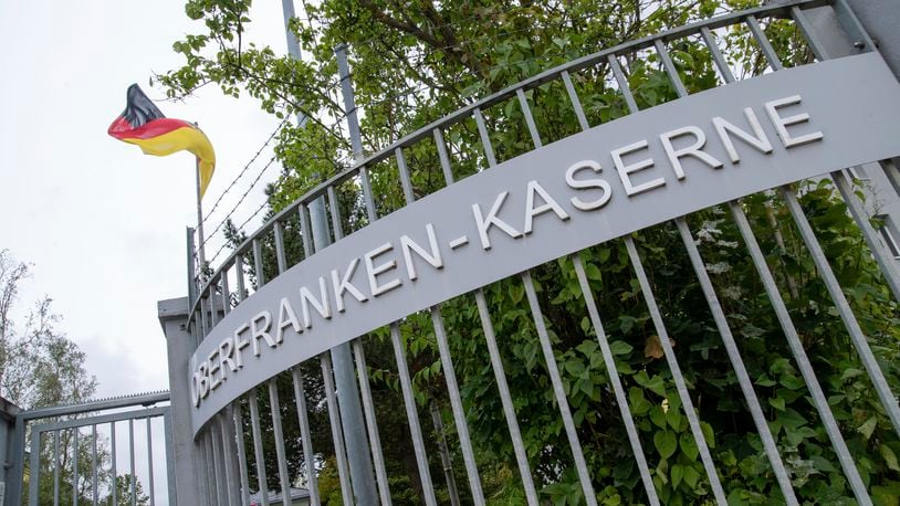 A German flag flies at the entrance to the Upper Franconia barracks, in Hof, Germany. Investigators in Bavaria have arrested a 27-year-old Syrian man for planning to attack Bundeswehr soldiers in Upper Franconia. (Pia Bayer/dpa via AP)