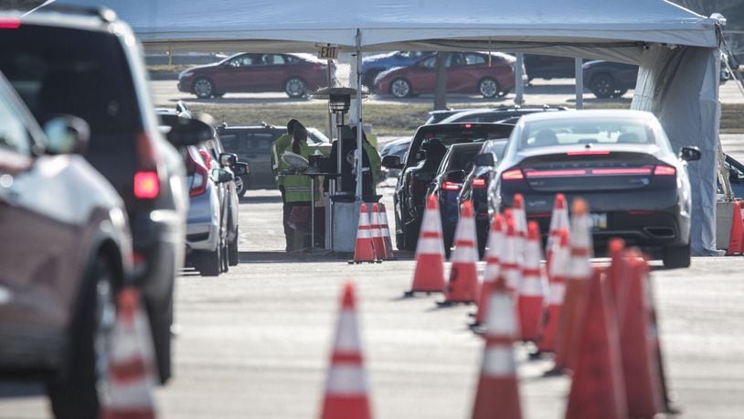 Lines for the drive-thru COVD-19 vaccine clinic held by Premier Health at the University of Dayton Arena on Edwin C Moses Boulevard stretched to I-75 on Thursday, Jan. 21. 2021. STAFF/JIM NOELKER