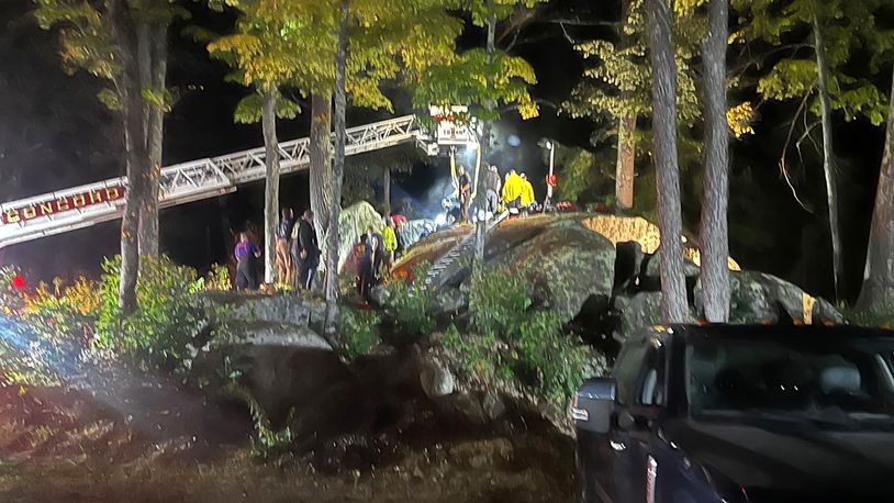 This Sunday, Sept. 15, 2024 photo provided by the Hillsborough Fire Department shows first responders at the scene of a rescue for a child who became wedged between two boulders, in Windsor, N.H. (Hillsborough Fire Department via AP)