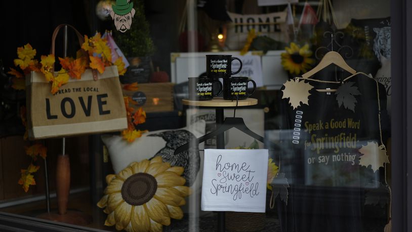 Items supporting Springfield, Ohio, including the slogan "Speak a Good Word for Springfield or say nothing," and "Hope Sweet Springfield," are displayed in the Champion City Guide & Supply shop window, Tuesday, Sept. 17, 2024, in Springfield, Ohio. (AP Photo/Carolyn Kaster)