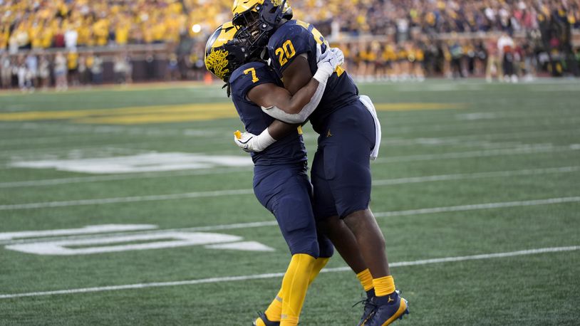 Michigan running back Kalel Mullings (20) celebrates his one-yard touchdown run with Donovan Edwards (7) in the second half of an NCAA college football game against Southern California in Ann Arbor, Mich., Saturday, Sept. 21, 2024. (AP Photo/Paul Sancya)