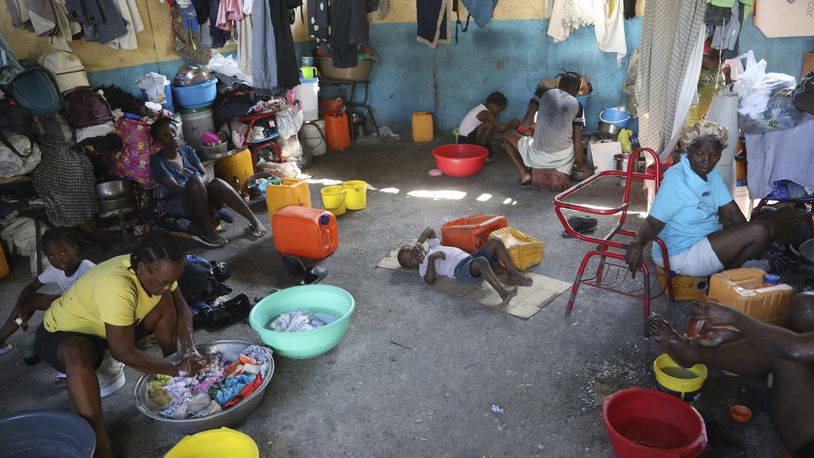 Families displaced by gang violence do laundry inside a school where they have been taking refuge for over a year in Port-au-Prince, Haiti, Friday, Sept. 20, 2024. (AP Photo/Odelyn Joseph)