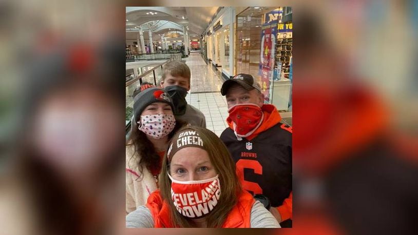 Walking at Fairfield Commons in Browns gear to remember Peter Scarff, Tecumseh Local School District Board of Education member and businessman, before the game Jan. 17. Kassidy Randall Dunham and Trenton Dunham with Sheli and Rusty Randall. Courtesy photo