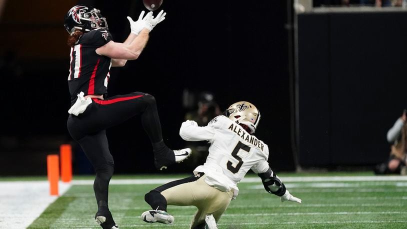 Atlanta Falcons tight end Hayden Hurst (81) makes the catch against New Orleans Saints middle linebacker Kwon Alexander (5) during the second half of an NFL football game, Sunday, Jan. 9, 2022, in Atlanta. (AP Photo/John Bazemore)