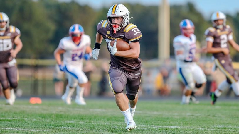 Kenton Ridge High School senior Jackson Patton carries the ball during their game against Northwestern on Friday, Sept. 13 at Richard L. Phillips Field in Springfield. The Cougars won 27-21 in double overtime. Michael Cooper/CONTRIBUTED