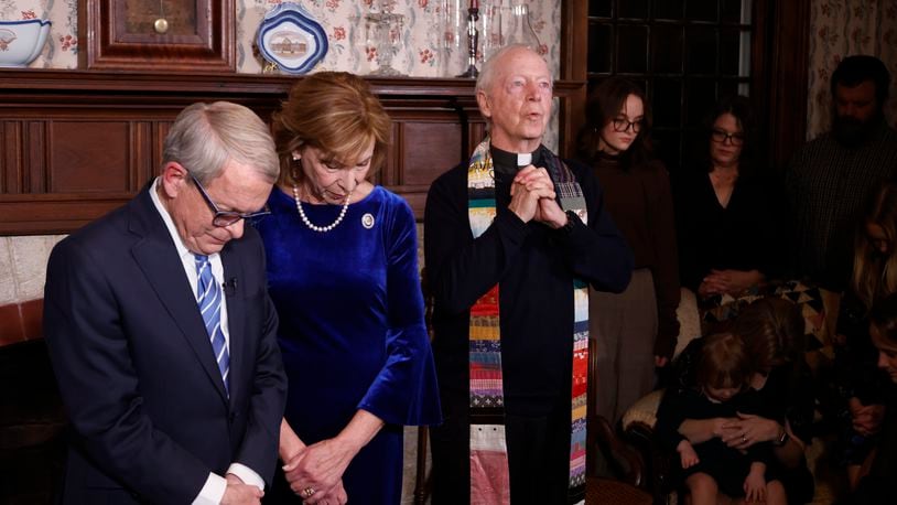 Fr. Tom Hagan, who founded the Becky DeWine School in Haiti, which was named after Gov. DeWine's late daughter, offers a prayer before Ohio Governor Mike DeWine takes the oath of the office during a private ceremony at his residence Sunday, Jan. 8, 2023, in Cedarville, Ohio, as his wife Fran DeWine. (AP Photo/Paul Vernon, Pool)