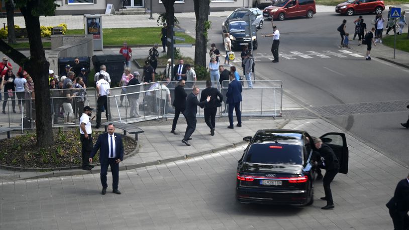FILE - Bodyguards take Slovak Prime Minister Robert Fico in a car from the scene after he was shot and injured following the cabinet's away-from-home session in the town of Handlova, Slovakia, on May 15, 2024. Slovakia’s authorities started to investigate a suspect in an attempted assassination on populist Prime Minister Robert Fico as a terror attack, the country’s prosecutor general said on Thursday, July 4, 2024. (Radovan Stoklasa/TASR via AP)