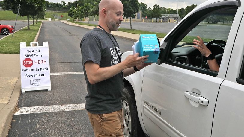 Chris Cook, Clark County Health Commissioner, is seen in this June 7, 2022 file photo handing out COVID-19 home test kits in a drive-thru set up in the parking lot at Springfield High School. BILL LACKEY/STAFF