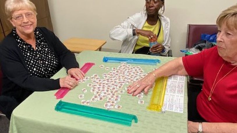 (From left) Roberta Patterson, Marilyn Barrett and Joan McGratty “shuffle” tiles before their next game at the Washington Township Rec Center where players gather Tuesdays and Thursdays. CONTRIBUTED