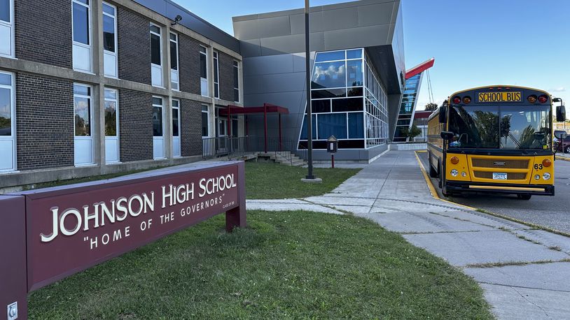 A school bus sits outside Johnson Senior High School in St. Paul, Minn., Sept. 5, 2024. (AP Photo/Doug Glass)