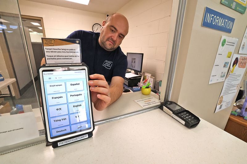 Paden Frank, from the Clark County Combined Health District, turns on the Health District's Translate Live device at the information desk Tuesday, August 27, 2024. BILL LACKEY/STAFF