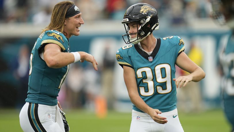 Jacksonville Jaguars place kicker Cam Little (39) celebrates with quarterback Trevor Lawrence (16) during the second half of an NFL football game against the Indianapolis Colts, Sunday, Oct. 6, 2024, in Jacksonville, Fla. (AP Photo/John Raoux)