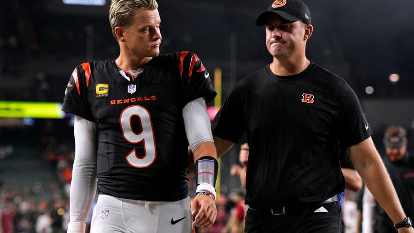 Cincinnati Bengals quarterback Joe Burrow (9) walks off the field with head coach Zac Taylor after an NFL football game against the Washington Commanders, Monday, Sept. 23, 2024, in Cincinnati. The Commanders won 38-33. (AP Photo/Jeff Dean)