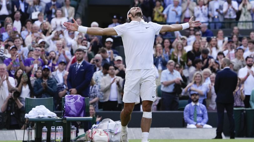 Lorenzo Musetti of Italy celebrates after defeating Taylor Fritz of the United States in their quarterfinal match at the Wimbledon tennis championships in London, Wednesday, July 10, 2024. (AP Photo/Alberto Pezzali)
