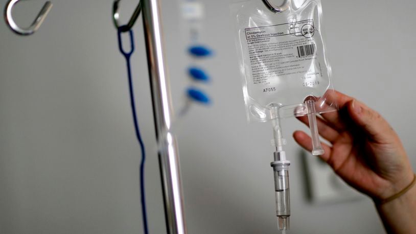 FILE - A nurse hooks up an IV to a flu patient at Upson Regional Medical Center in Thomaston, Ga., Feb. 9, 2018. (AP Photo/David Goldman, File)