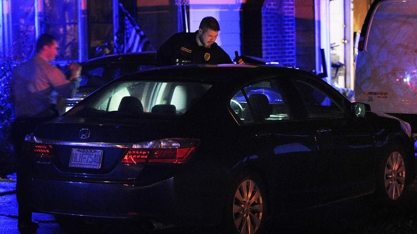 Members of the Springfield Police Division look over a car at a home on Selma Pike Sunday night Nov. 6, 2022 involved in homicide on Willis Ave. in Springfield. MARSHALL GORBY\STAFF