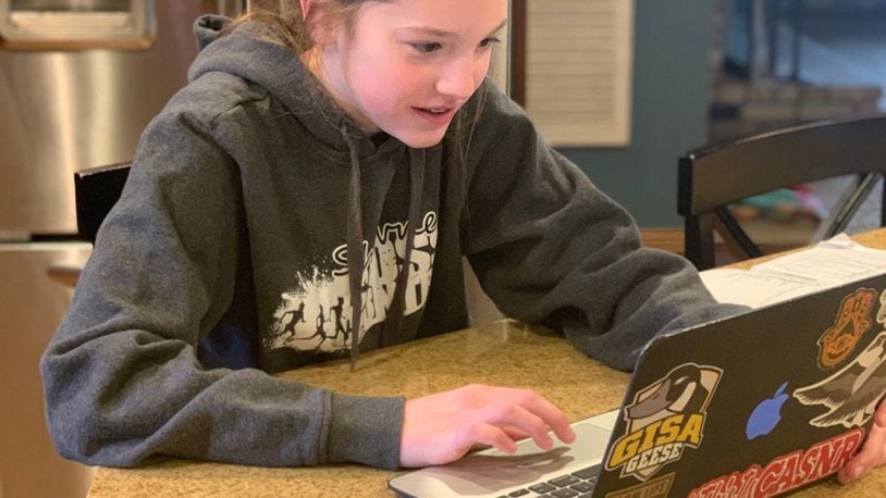 Josie Jennings, a middle school student at Global Impact STEM Academy, partakes in virtual learning from the comfort of her own home during the coronavirus pandemic and subsequent school closures. CONTRIBUTED