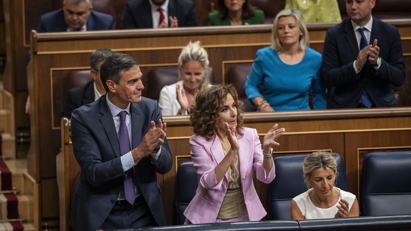 From left to right: Spain's Socialist Prime Minister Pedro Sanchez, Spain's Deputy Prime Minister and Ministry of Finance Maria Jesus Montero and Spain's second Deputy Prime Minister and Labour Minister Yolanda Diaz applaud after the approval to an amnesty law at the Spanish parliament's lower house in Madrid on Thursday, May 30, 2024. Spain's Parliament has given final approval to a controversial amnesty law for hundreds of Catalan separatists involved in the illegal and unsuccessful 2017 secession bid. The legislation was backed in the lower house by Spain's left-wing coalition government, two Catalan separatist parties, and other smaller parties. It passed despite the conservative Popular Party and far-right Vox voting against it. (AP Photo/Bernat Armangue)