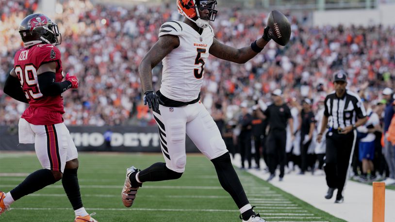 Cincinnati Bengals wide receiver Tee Higgins (5) scores a touchdown against the Tampa Bay Buccaneers in the first half of an NFL preseason football game Saturday, Aug. 10, 2024, in Cincinnati. (AP Photo/Jeff Dean)