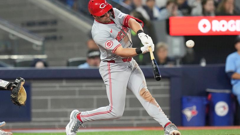 Cincinnati Reds' Spencer Steer hits an RBI double against the Toronto Blue Jays during sixth-inning baseball game action in Toronto, Monday, Aug. 19, 2024. (Chris Young/The Canadian Press via AP)