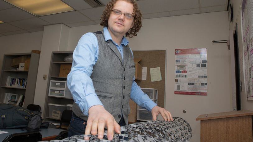 UC graduate student Mark Haase is conducting experiments using carbon nanotubes at UC’s Nanoworld Laboratories and at Wright Patterson’s Air Force Research Lab. A model in front of him demonstrates their lattice structure. PHOTOS BY JOSEPH FUQUA II/UC CREATIVE SERVICES