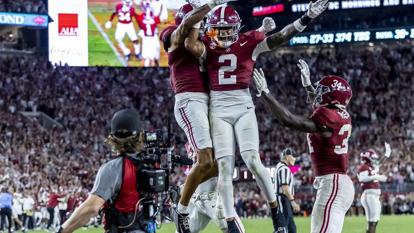 Alabama defensive back Domani Jackson, left, celebrates with defensive back Zabien Brown (2) and linebacker Que Robinson (34) after Brown intercepted a pass in the final minute during the second half of an NCAA college football game against Georgia, Saturday, Sept. 28, 2024, in Tuscaloosa, Ala. (AP Photo/Vasha Hunt)