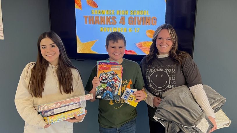 Shawnee High School is hosting a Thanks 4 Giving donation drive for staff and students to bring in items to donate to two local organizations who provide resources and support to Clark County residents. In this photo is Reese Chilcote (left), Evan Brown (middle) and Olivia Lemon (right). Contributed