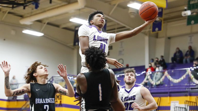 Emmanuel Christian Academy junior Justus Channels drives to the hoop against Yellow Springs' Malik Thomas during their game on Tuesday, Dec. 15. Channels and his brother Jason are two of the top scorers in the Metro Buckeye Conference this season. Michael Cooper/CONTRIBUTED