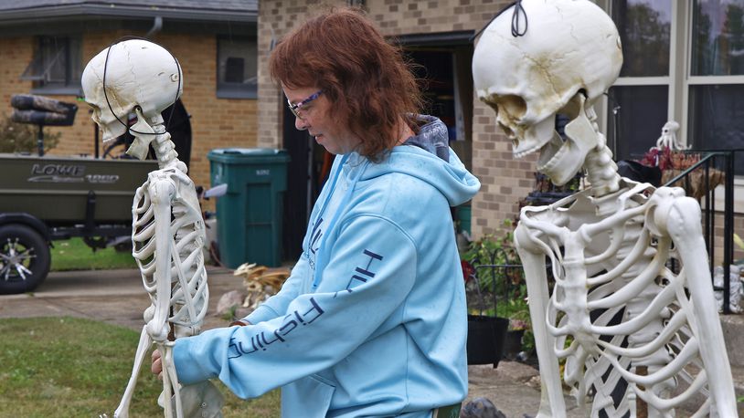 Valorie Hubbard was hanging out with some skinny friends as she sets up her Halloween display Thursday, Oct. 5, 2023 in her front yard along Tulane Road in Moorefield Township. BILL LACKEY/STAFF