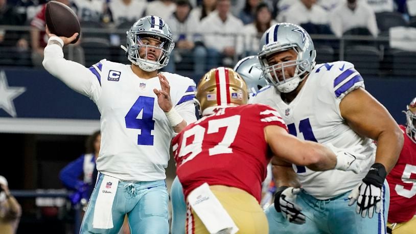 Dallas Cowboys quarterback Dak Prescott (4) throws a pass as offensive tackle La'el Collins (71) helps against pressure from San Francisco 49ers defensive end Nick Bosa (97) in the first half of an NFL wild-card playoff football game in Arlington, Texas, Sunday, Jan. 16, 2022. (AP Photo/Tony Gutierrez)