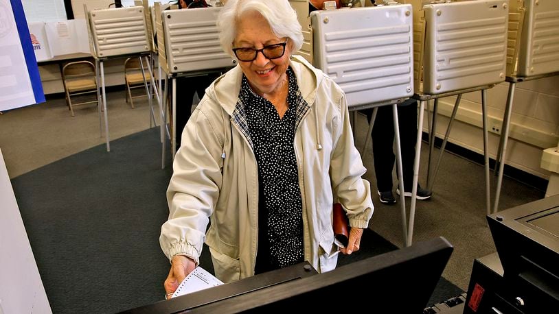 Jennie Zimmer slides her ballot into the voting machine after voting early at the Clark County Board of Elections Tuesday, Oct. 17, 2023. BILL LACKEY/STAFF