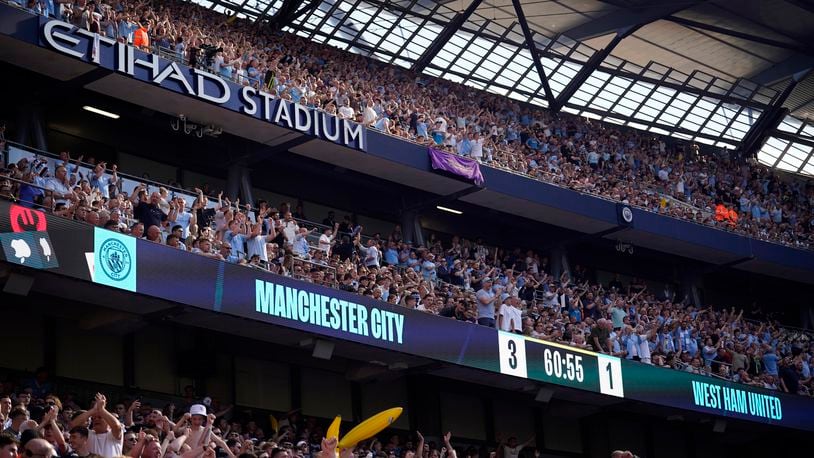 FILE - Manchester City fans celebrate after Manchester City's Rodrigo scores his side's third goal during the English Premier League soccer match between Manchester City and West Ham United at the Etihad Stadium in Manchester, England, Sunday, May 19, 2024. (AP Photo/Dave Thompson, File)