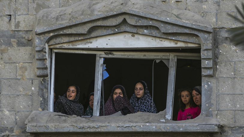 FILE - Palestinians look at the destruction after an Israeli airstrike on a crowded tent camp housing Palestinians displaced by the war in Muwasi, Gaza Strip, Sept. 10, 2024. (AP Photo/Abdel Kareem Hana, file)