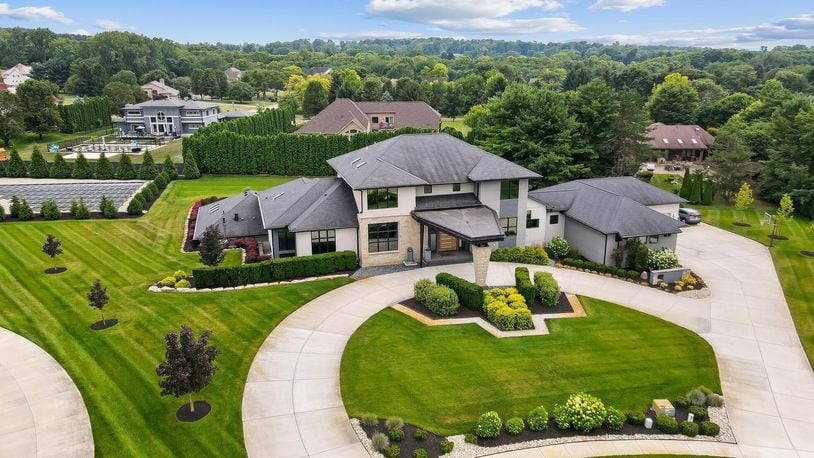 The front of the home has a circular driveway leading to the front of the home and covered front porch as well as the four car attached garage.