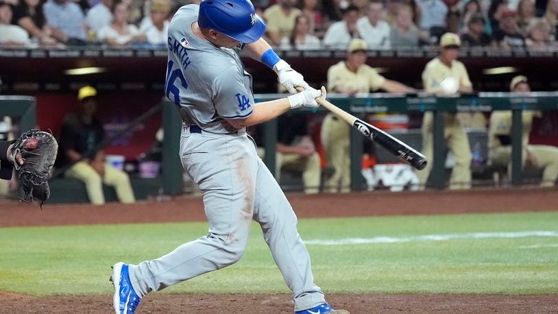 Los Angeles Dodgers' Will Smith connects for a three-run home run against the Arizona Diamondbacks during the seventh inning of a baseball game Friday, Aug. 30, 2024, in Phoenix. (AP Photo/Ross D. Franklin)