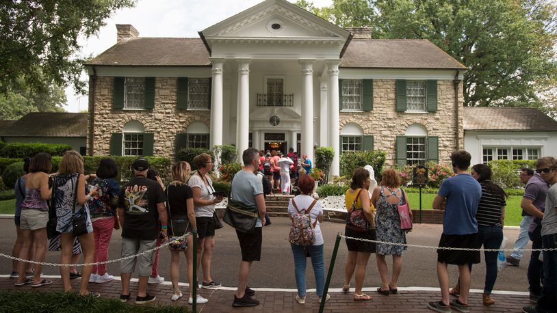 FILE - Fans wait in line outside Graceland, Elvis Presley's Memphis home, in Memphis, Tenn., Aug. 15, 2017. A mysterious company has caused a stir for trying to auction Elvis Presley's Graceland in a foreclosure sale this week. A judge has blocked the sale after Presley's granddaughter filed a lawsuit alleging fraud. (AP Photo/Brandon Dill, File)
