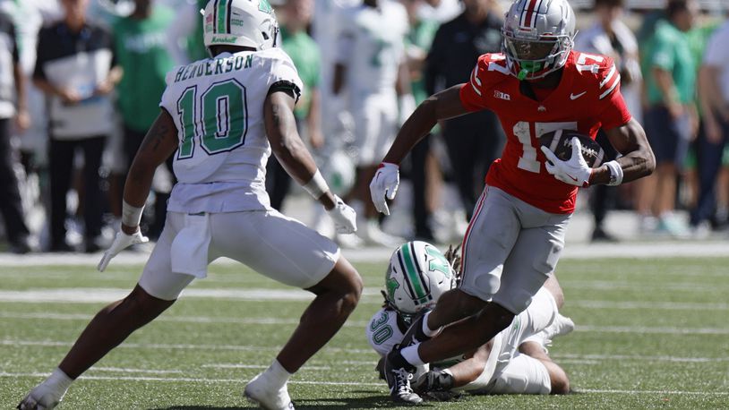 Ohio State receiver Carnell Tate, right, is tackled by Marshall linebacker Jaden Yates during the second half of an NCAA college football game, Saturday, Sept. 21, 2024, in Columbus, Ohio. (AP Photo/Jay LaPrete)